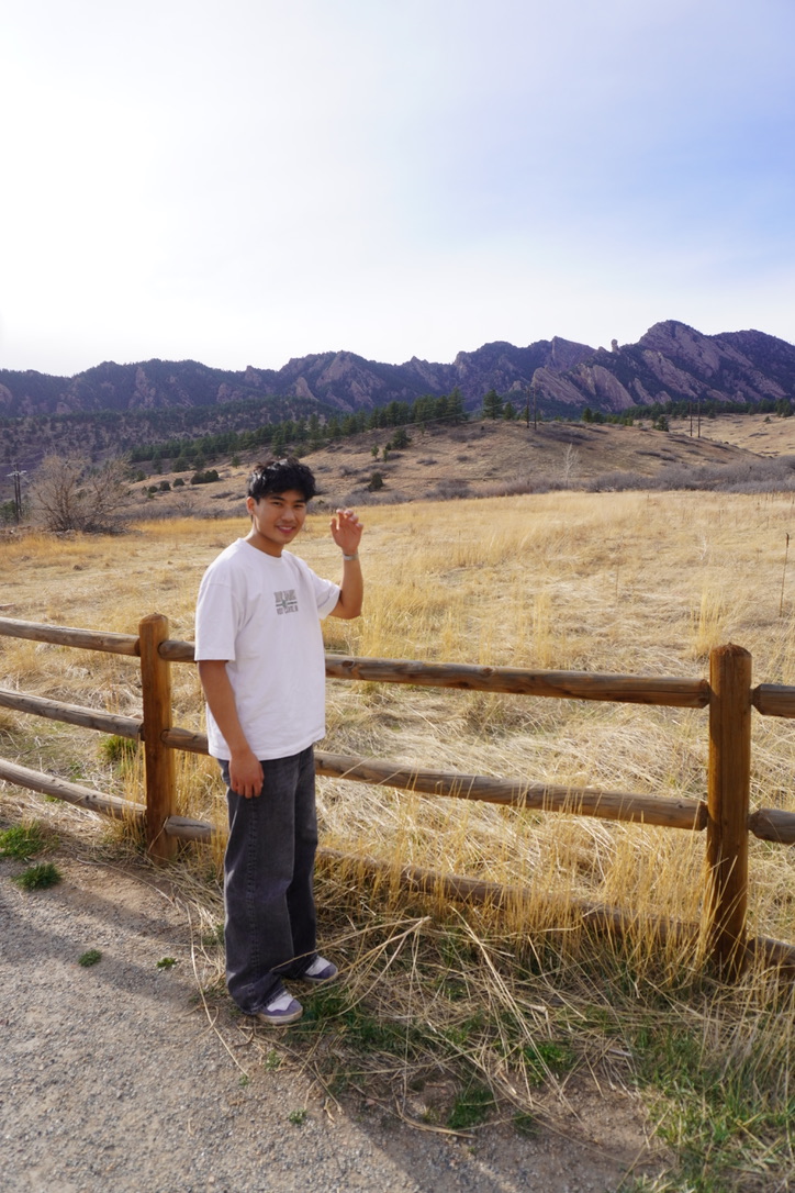 J.J. standing in front of the Flatirons mountains